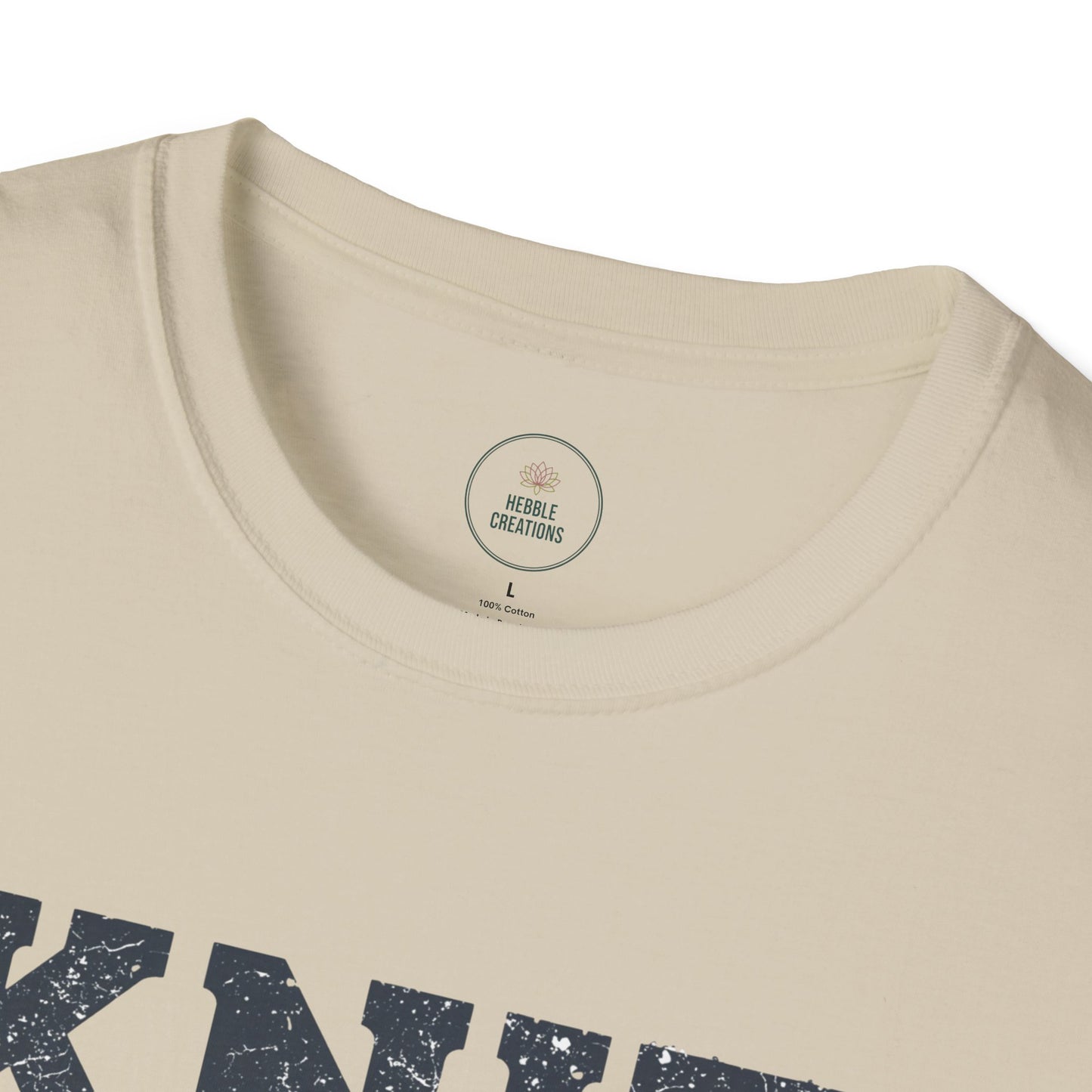 Beige t-shirt with navy text and a visible brand label on a white background