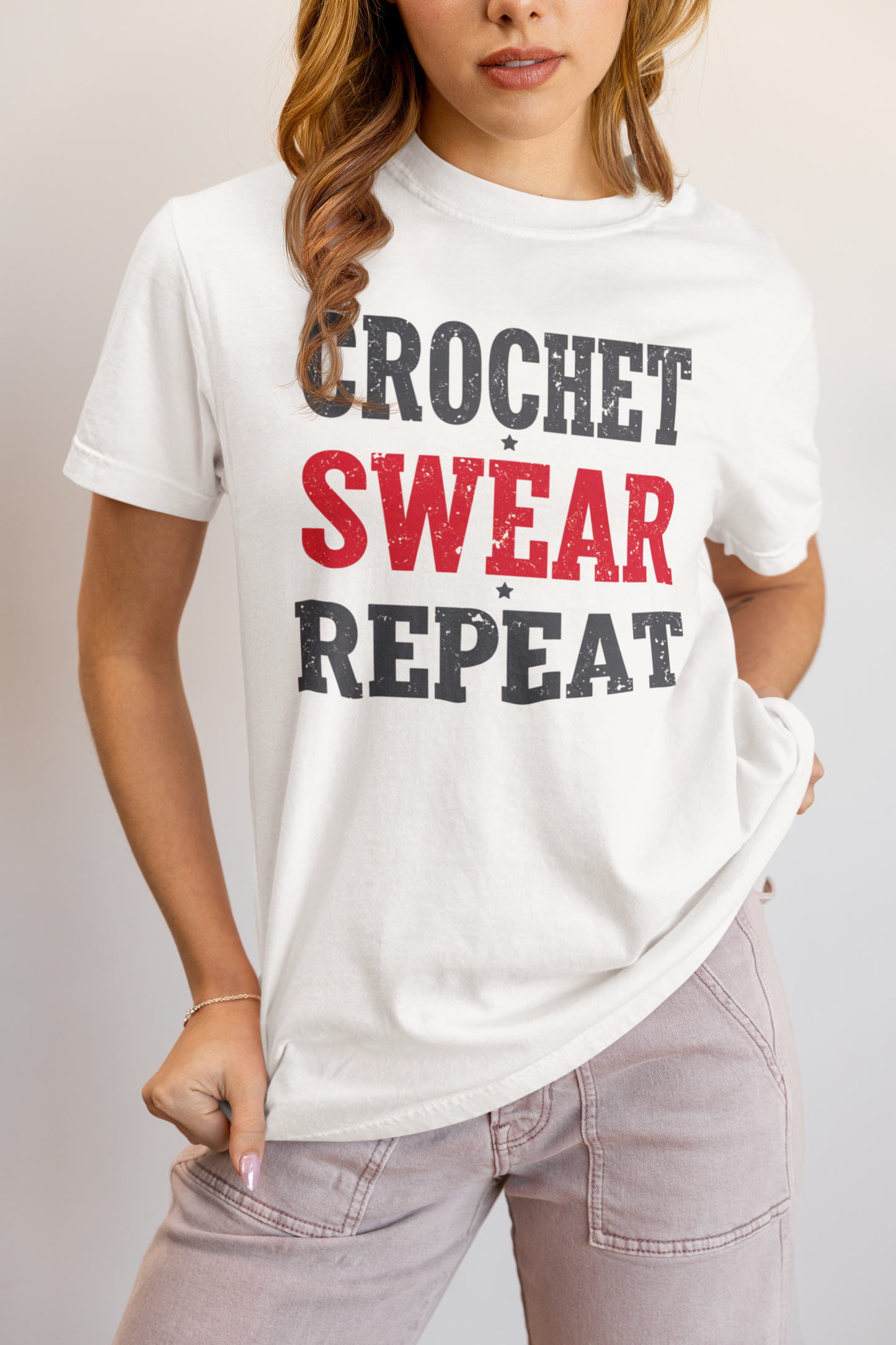 Person wearing a white t-shirt with 'Crochet Swear Repeat' text design.