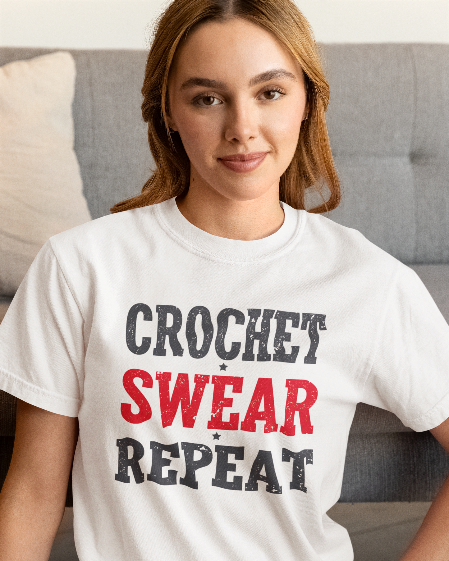 Woman wearing a white t-shirt with 'Crochet Swear Repeat' text.
