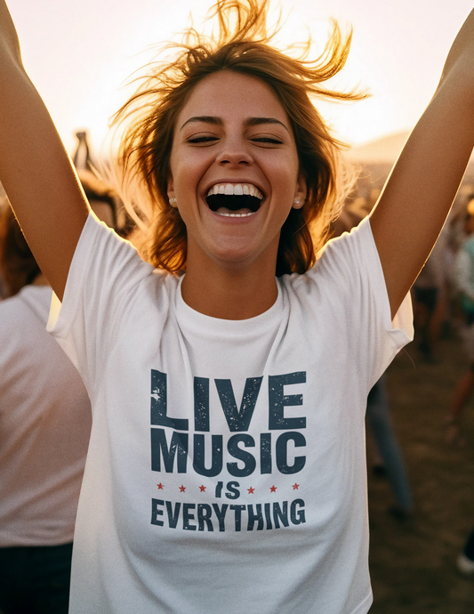 Woman wearing a 'Live Music is Everything' t-shirt with arms raised outdoors.