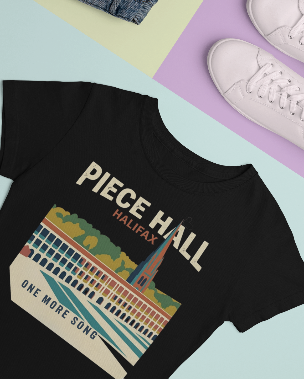 Black t-shirt with 'Piece Hall Halifax' design on a colorful background
