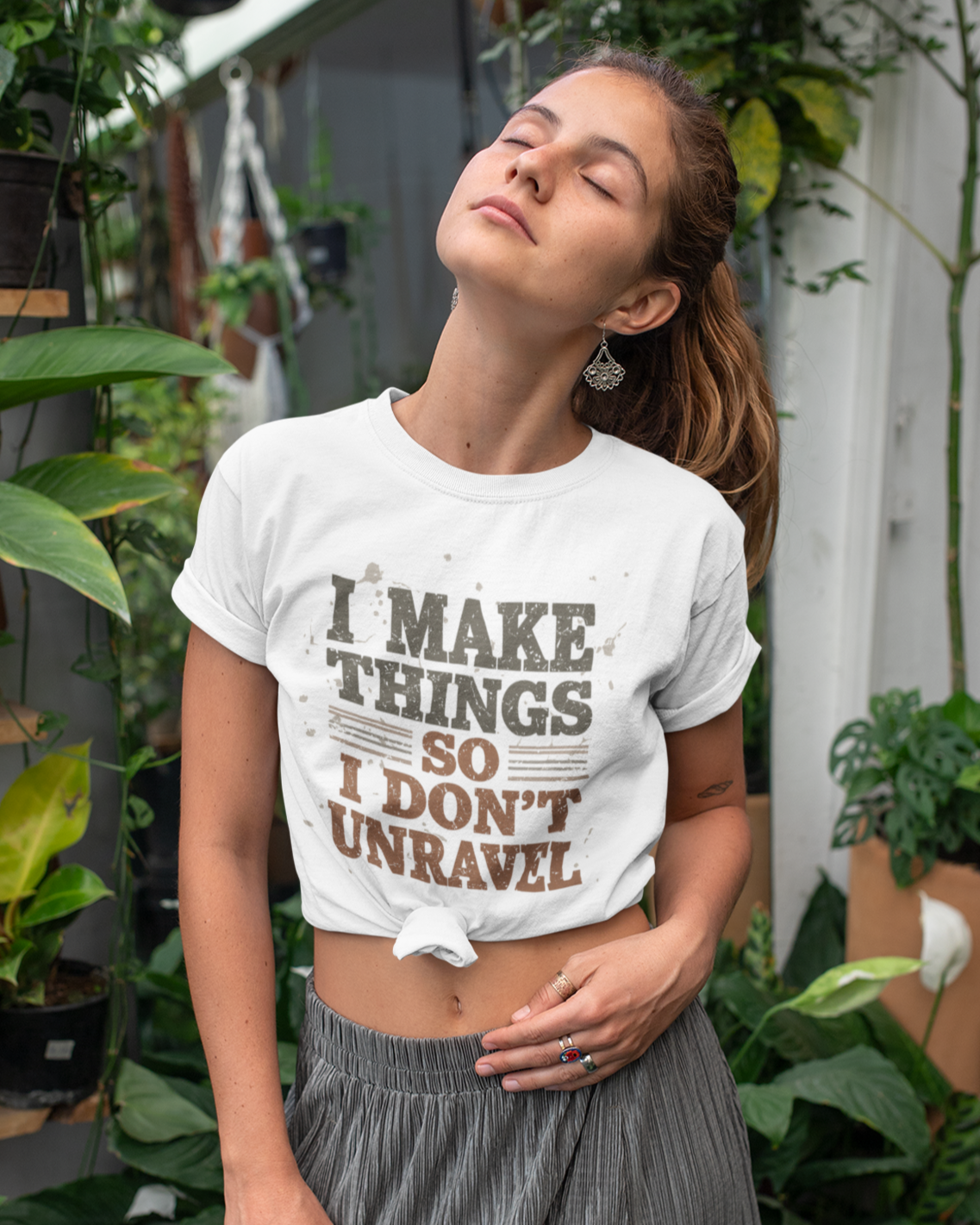 Woman wearing a white t-shirt with text in an outdoor setting