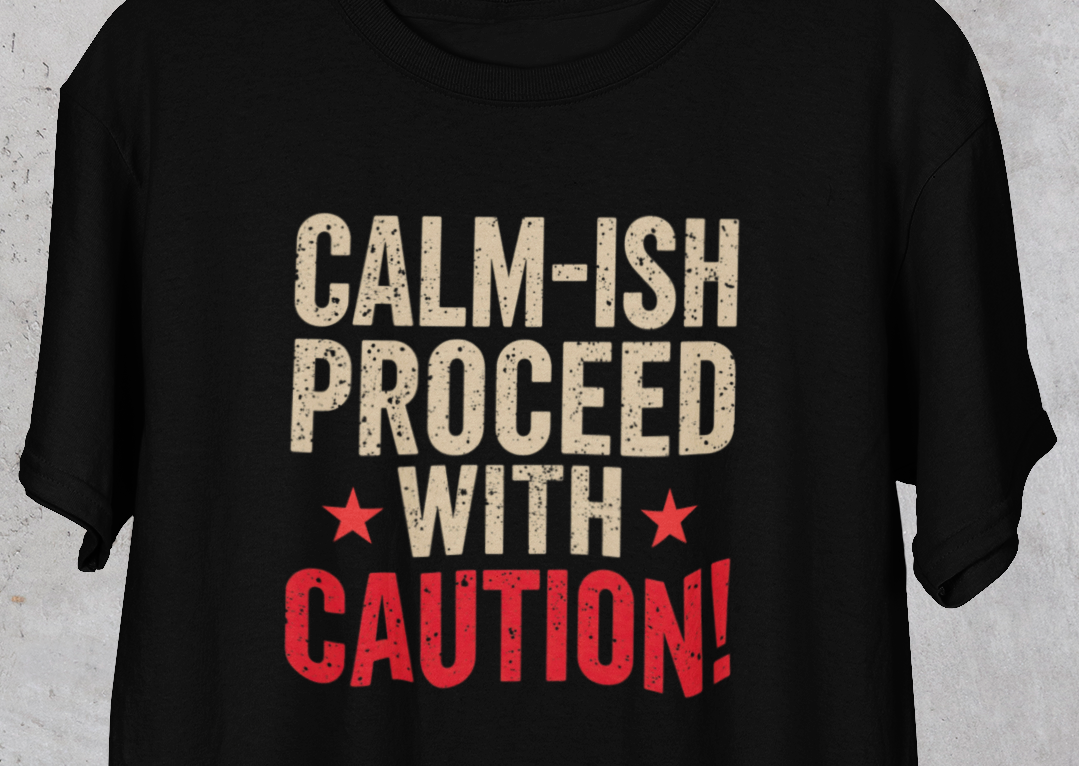 Black t-shirt with 'CALM-ISH PROCEED WITH CAUTION!' text on a gray background