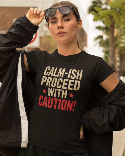 Person wearing a black t-shirt with humorous text design outdoors.