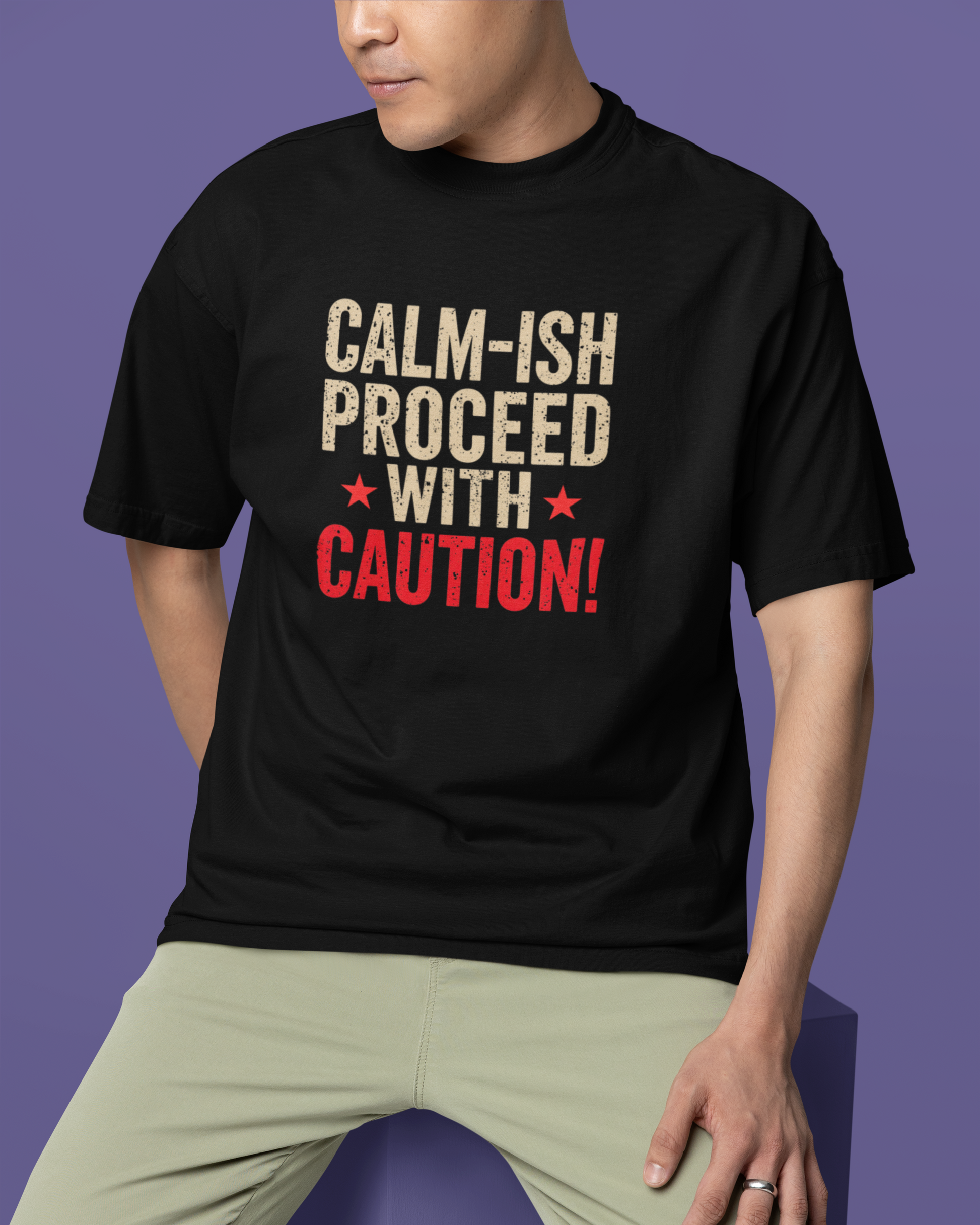 Person wearing a black t-shirt with humorous text design on a purple background