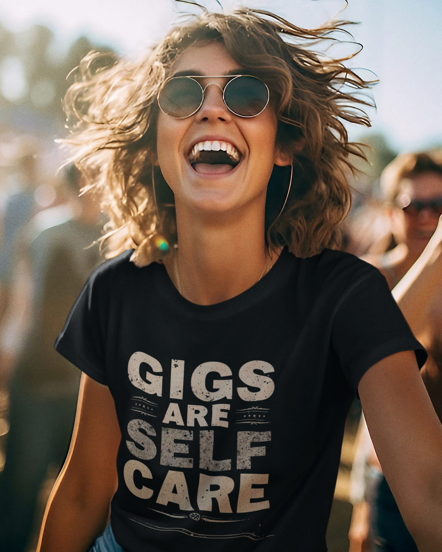 Woman wearing sunglasses and a black t-shirt with 'GIGS ARE SELF CARE' text at an outdoor event.