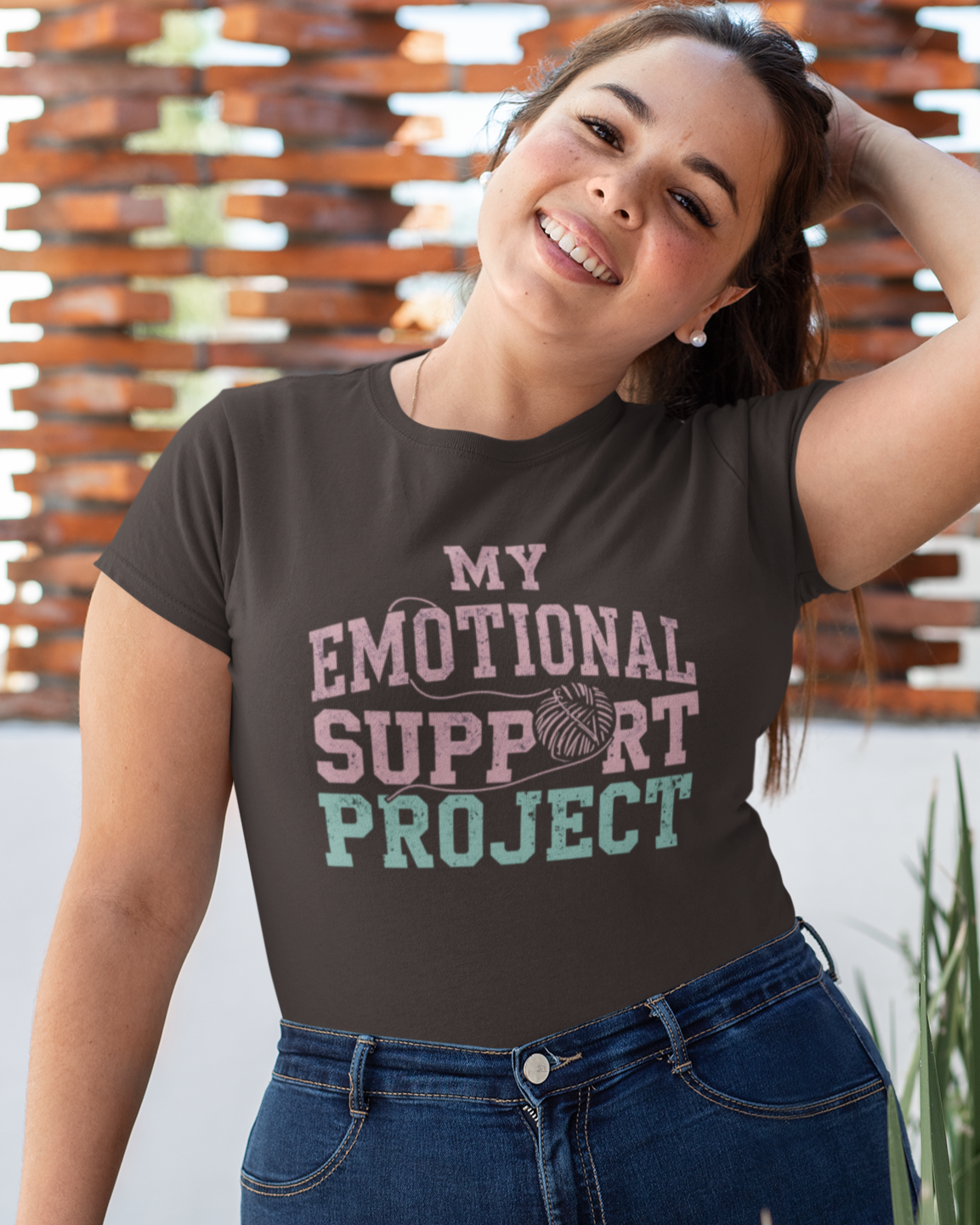 Person wearing a dark brown t-shirt with 'My Emotional Support Project' text.