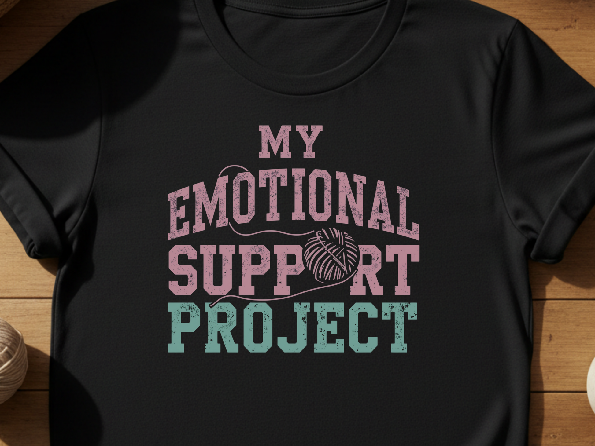 Black t-shirt with 'My Emotional Support Project' text on a wooden surface