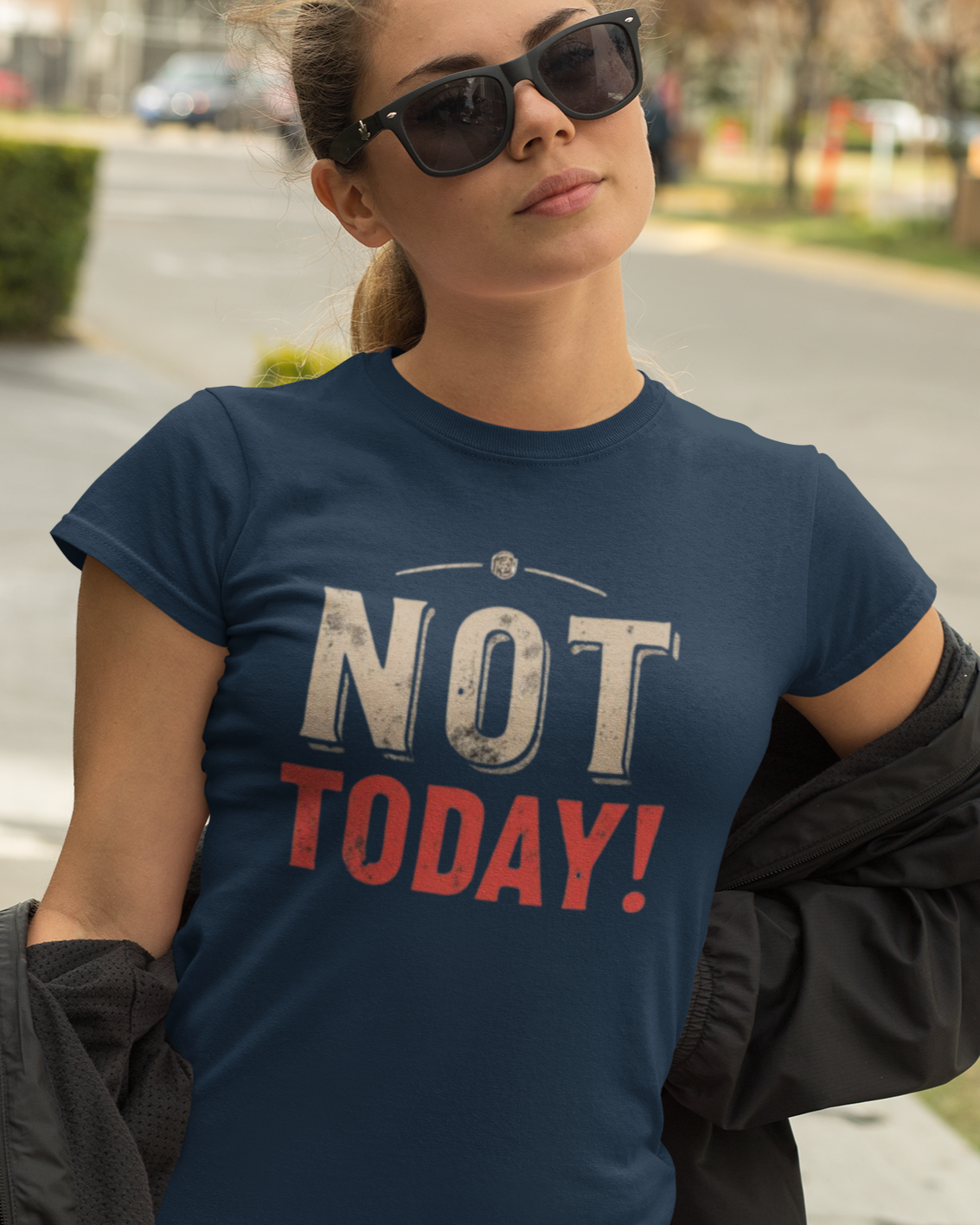 Woman wearing a navy blue t-shirt with 'NOT TODAY!' text outdoors.