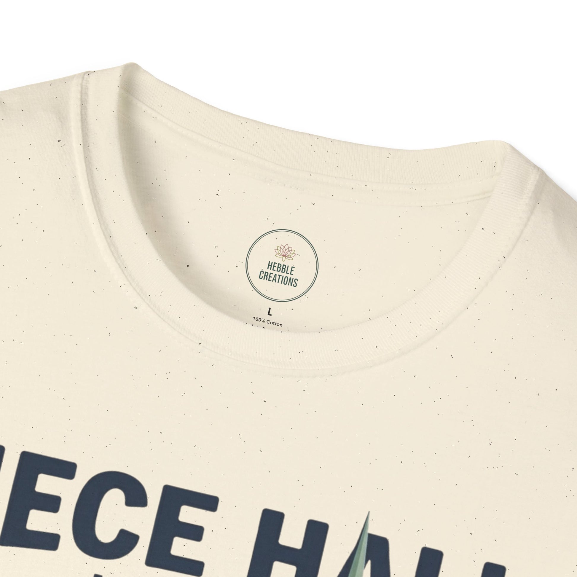 Close-up of a beige t-shirt with text and a visible brand label on a white background